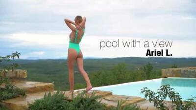 Lovely girl has a swimming pool with an amazing view, and likes posing nude next to it on vidgratis.com