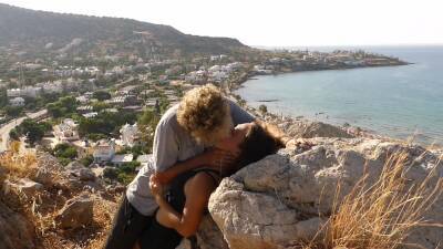 Beautiful Teen Couple In Love Passionately Kissing Above The Sea On Crete Island on vidgratis.com