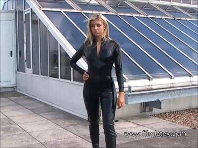 Blonde latex-babes outdoor knee boots and high heels of fetish girl in tight full body rubber outfit with softcore glamour model Karina outside on the roof on vidgratis.com