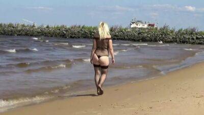 Pretty Woman In A Nylon Bodysuit On The Beach on vidgratis.com