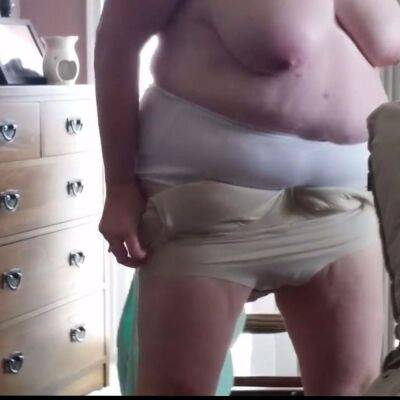 Putting on creame, girdle, clothes over her big tits on vidgratis.com