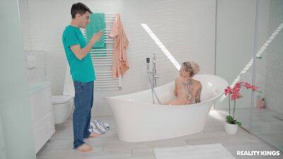 Inked MILF welcomes horny stepson into the tub for some sex fun on vidgratis.com