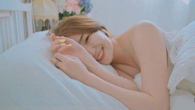 Good morning with young and beautiful Korean woman basking in bed - North Korea on vidgratis.com