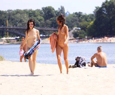 Petite nudist teen enjoys a beautiful day at the beach on vidgratis.com