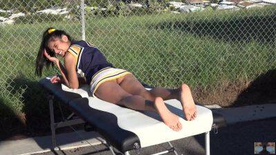 Cheerleader without panties sunbathing on the massage table on vidgratis.com