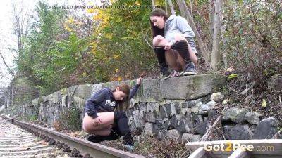 Watch these kinky girls get soaked in pee while getting frisky on the railway on vidgratis.com