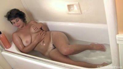 Big-titted brunette, Sayge, indulges in a steamy shower session and soaps up on vidgratis.com